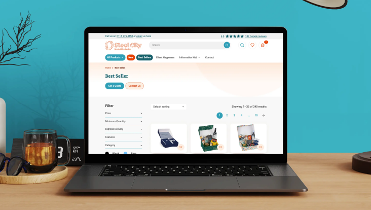 A laptop on a desk displaying the Steel City Website against a blue background. 